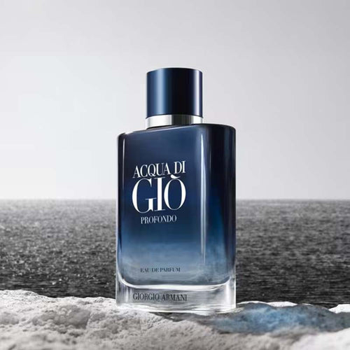 Giorgio Armani Acqua di Giò Profondo perfume bottle on a beach with ocean in the background