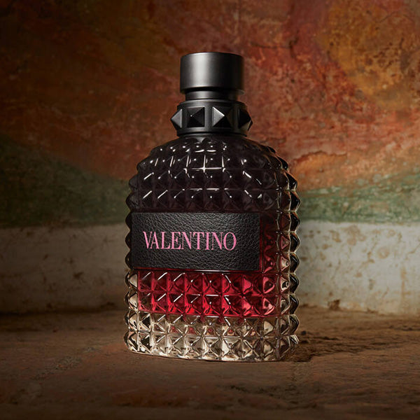 Valentino Born in Roma Intense perfume bottle with textured design on a rustic background