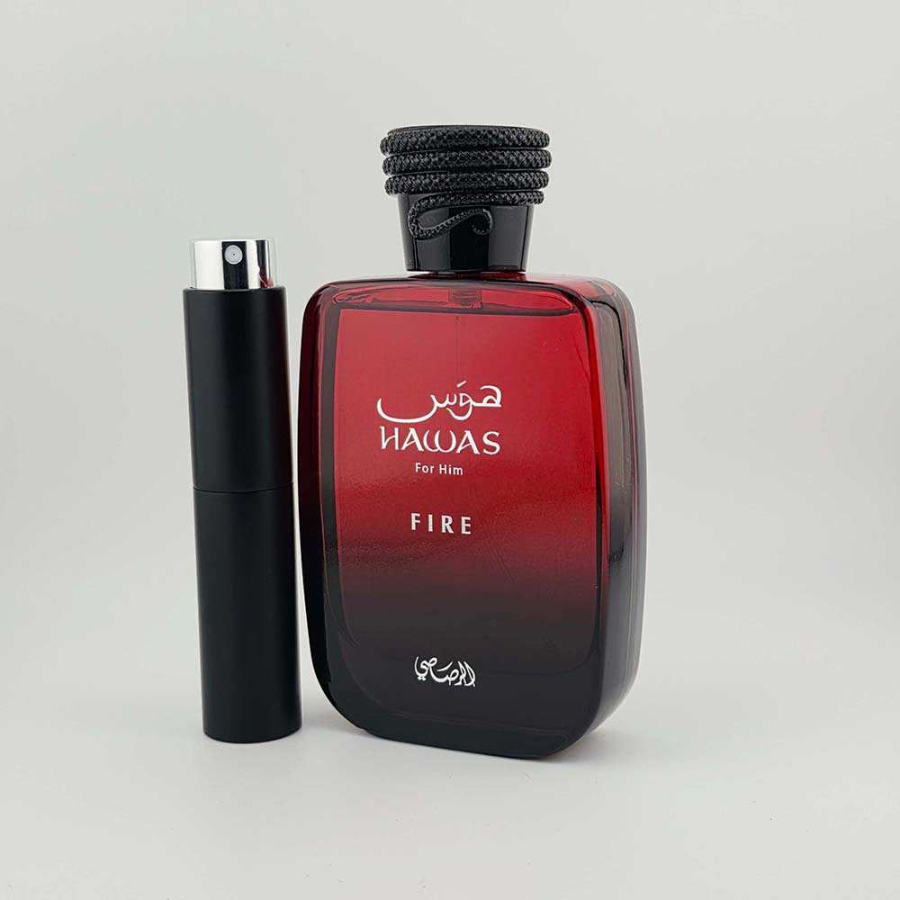 Hawas Fire by Rasasi EDP bottle with black travel atomizer on white background.