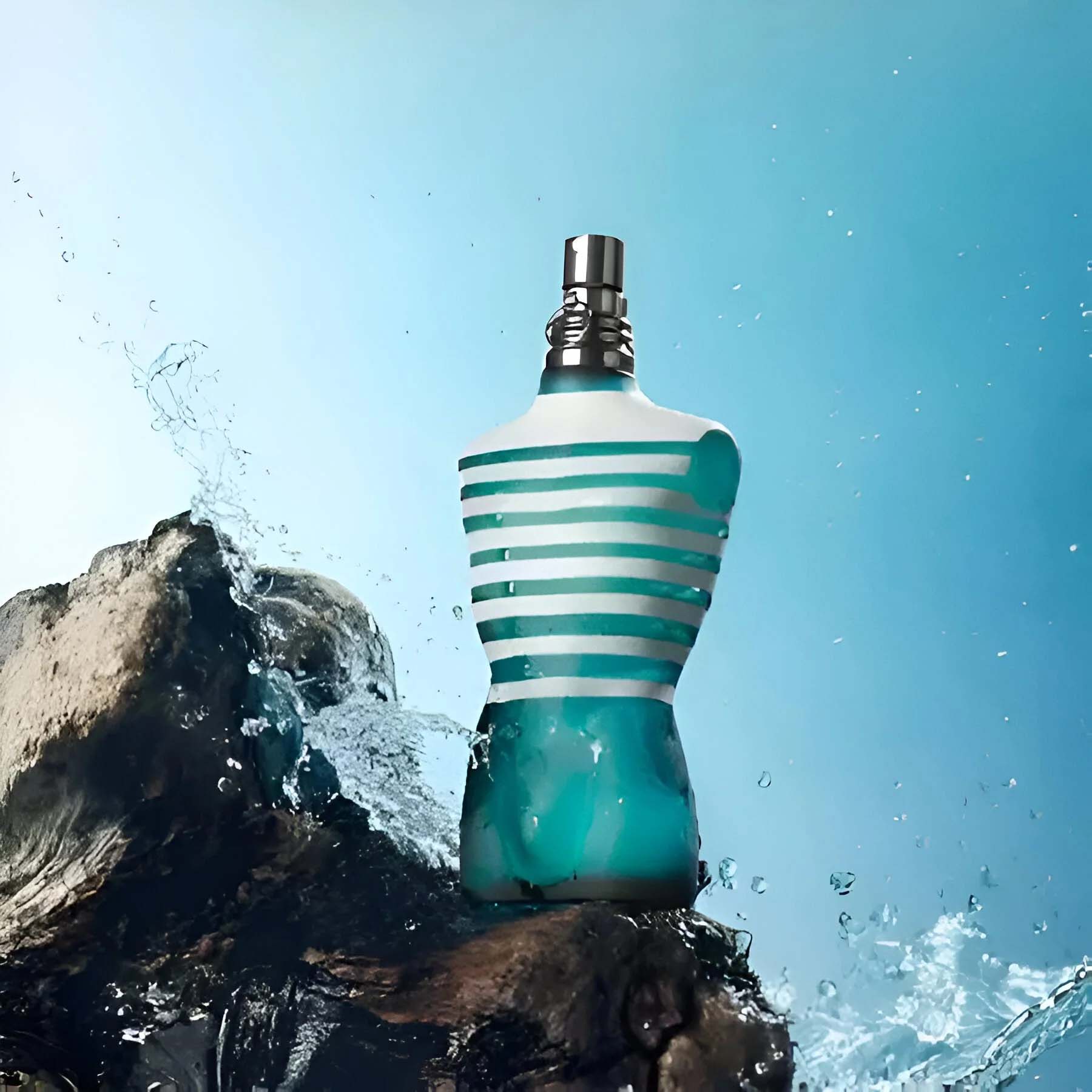 Jean Paul Gaultier Le Male bottle with ocean splash and rocky backdrop