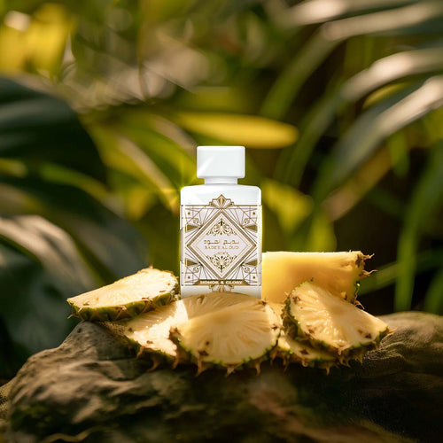 Lattafa Bade'e Al Oud Honor & Glory EDP bottle with sliced pineapple on tropical jungle background