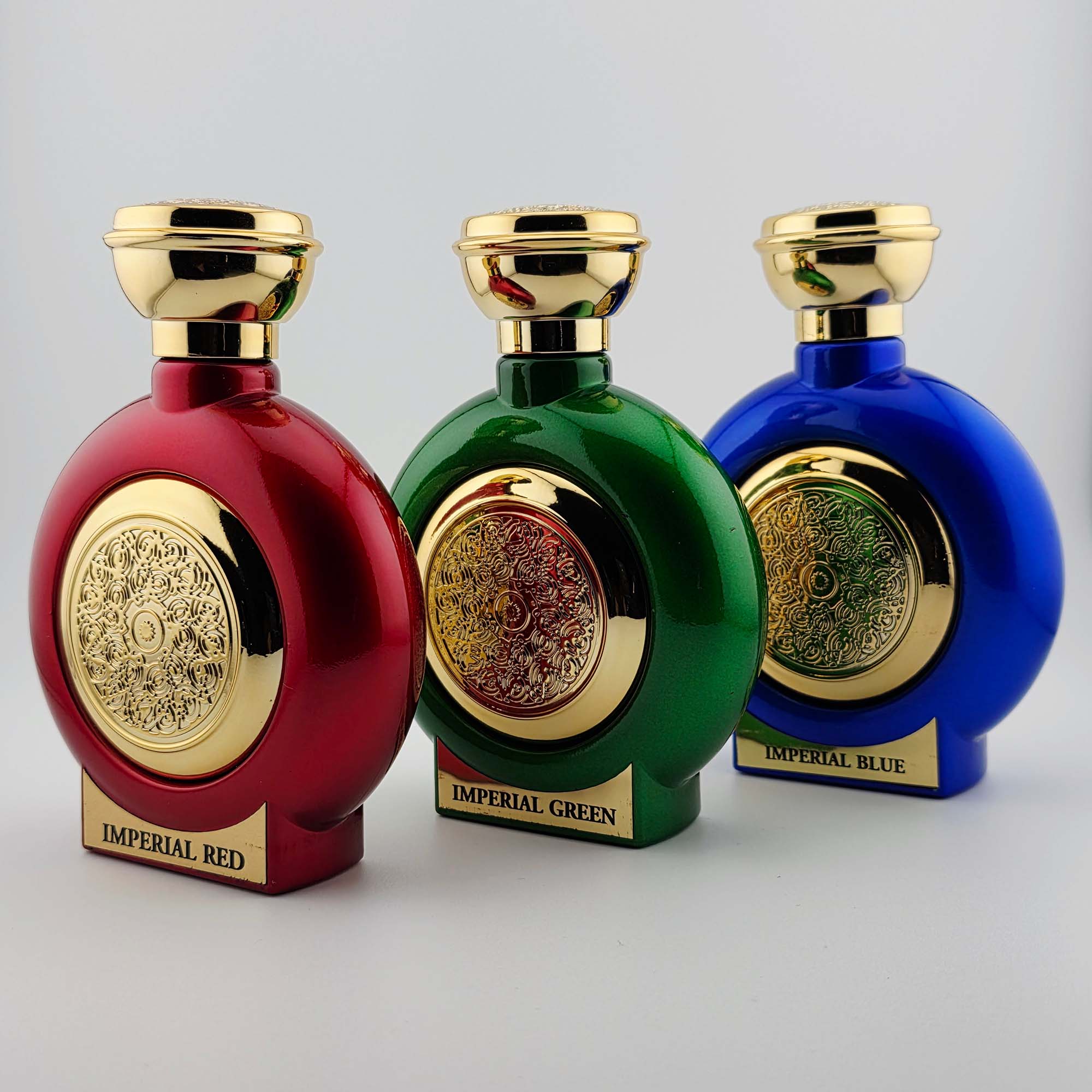 Loui Martin Imperial Red, Green, and Blue fragrance bottles with gold embossed detailing, displayed as a luxury trio
