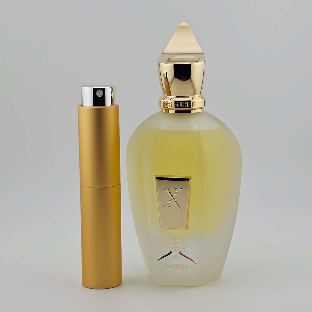 XJ 1861 Naxos by Xerjoff EDP bottle with matching gold travel atomizer on white background.